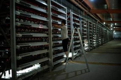 Vast crypto mining farm with rows of mining rigs displaying intense activity